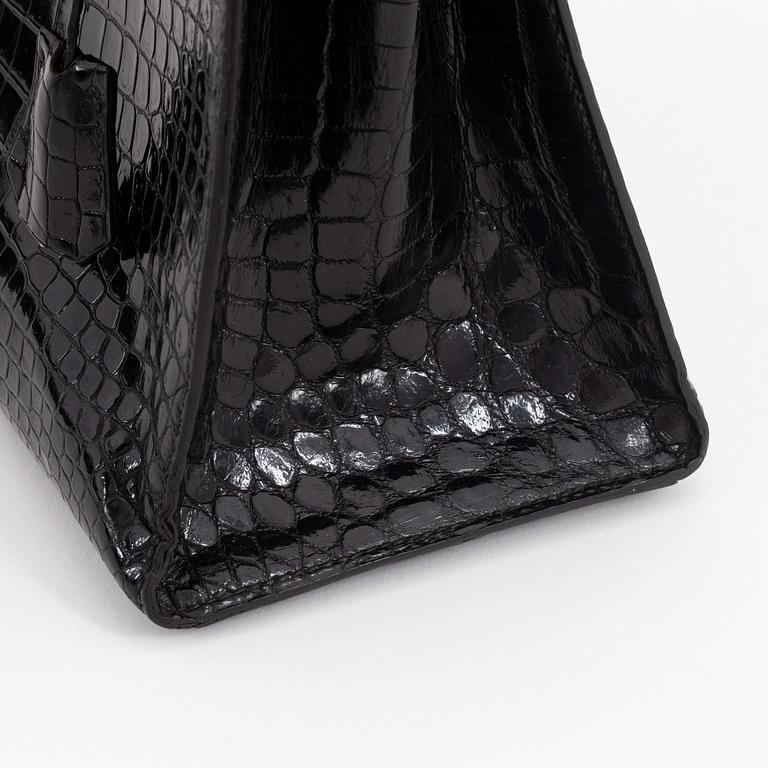 1962 black alligator 'Kelly' handbag by Hermès.