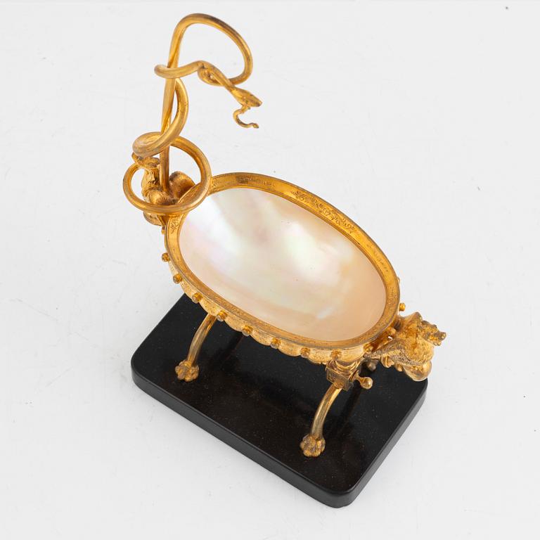 A gilt-brass, mother of pearl and diabase pocket-watch stand, late 19th century.