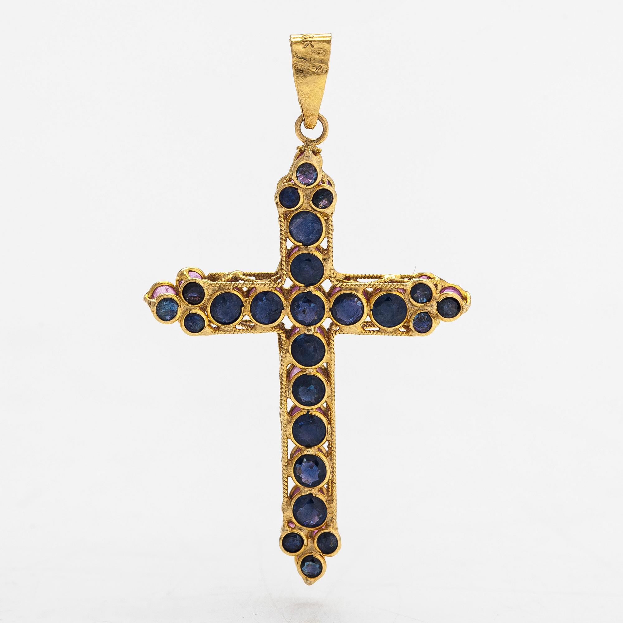 An 18K gold cross pendant with sapphires. Finnish import marks.