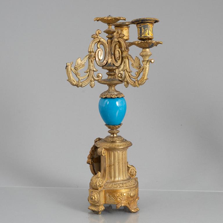 A Louis XVI style mantel clock and a pair of candelabra, circa 1900.