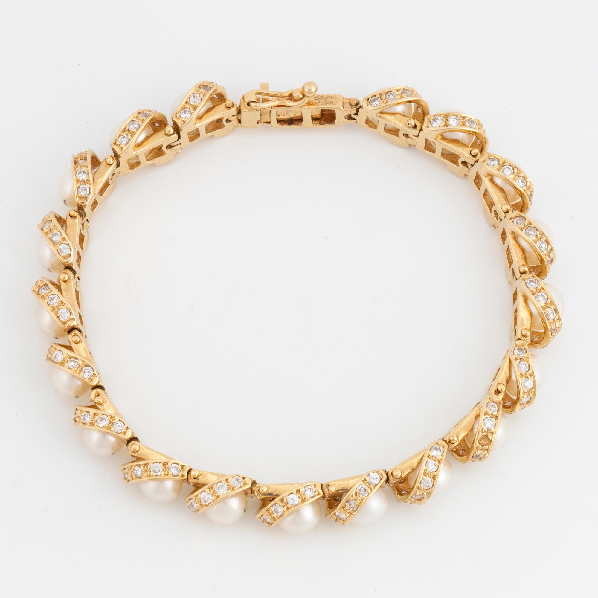 ARMBAND 14K guld, diamanter och pärlor.