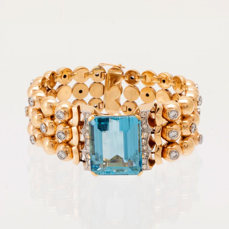 An 18K white and red gold bracelet set with rectangular step-cut aquamarine and round old-cut and brilliant-cut diamonds.