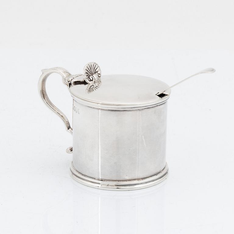 An English silver mustard pot and spoon, unidentified makers mark, London 1881 and the spoon 1874.