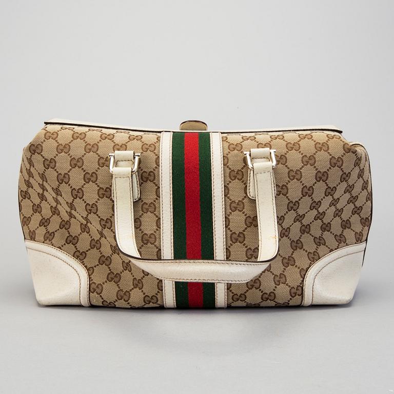A Gucci canvas and leather hand bag.