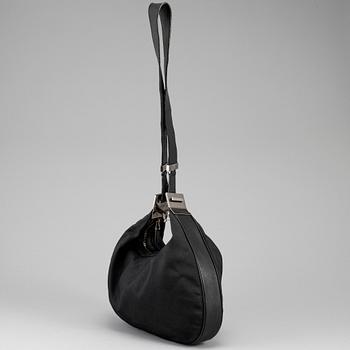 GUCCI, a canvas handbag.