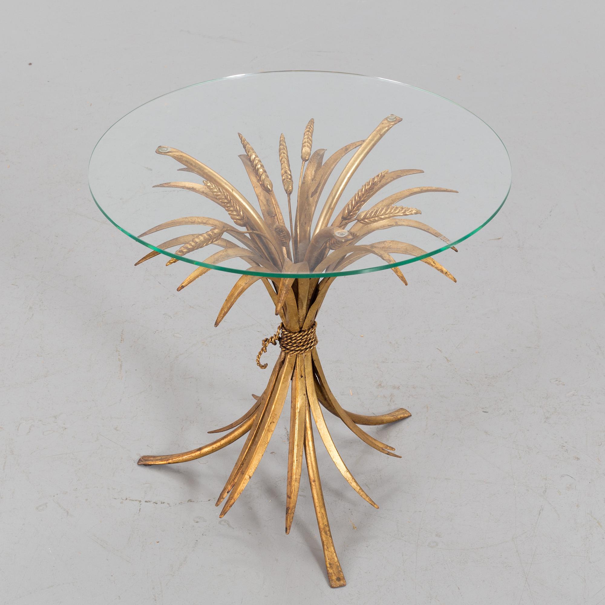 A HANS KÖGL ROUND GLAS AND GUILT METAL SMALL COFFEE TABLE.