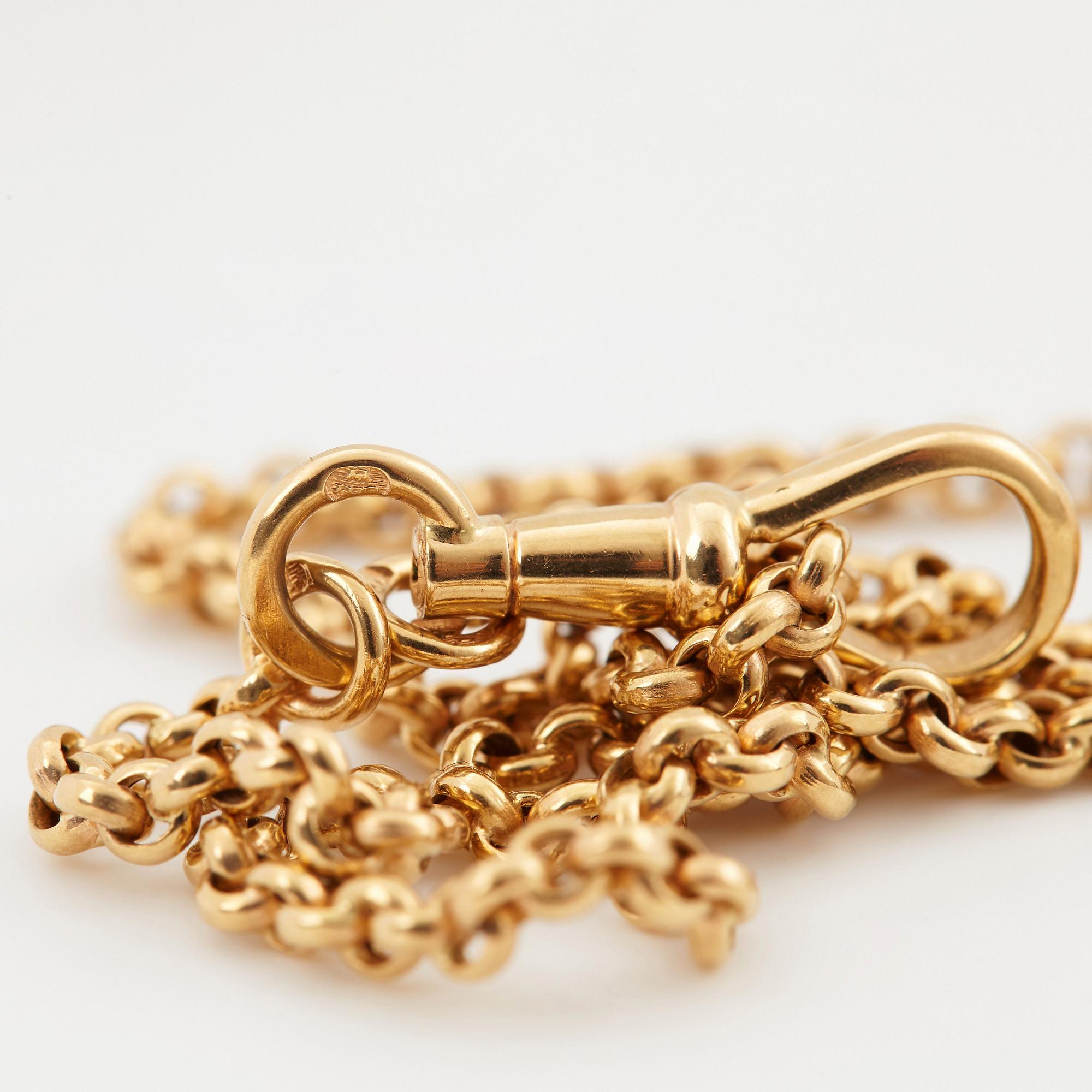 An 18K gold locket set with rose-cut diamonds.