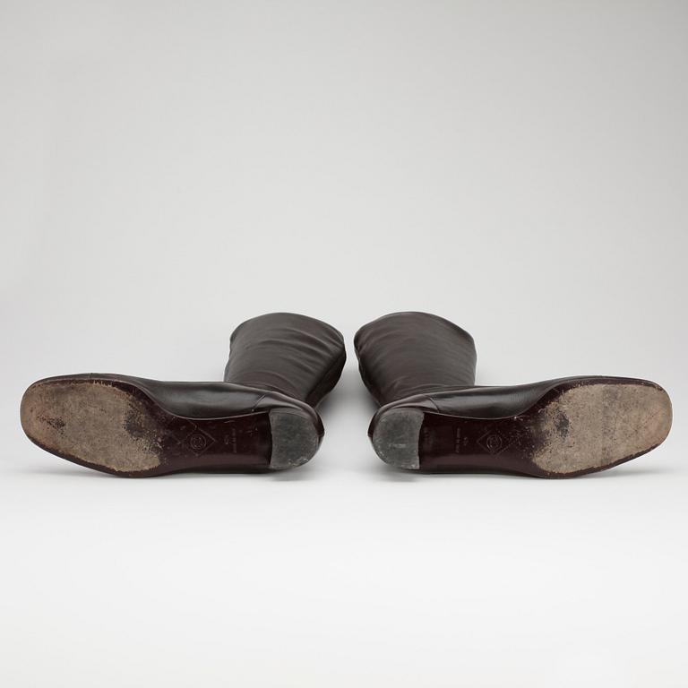 CHANEL a pair of brown leather boots.