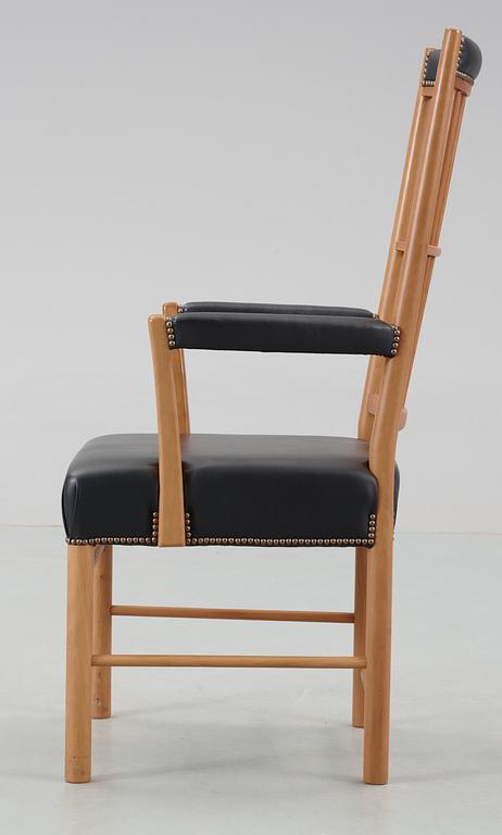 A Josef Frank cherrywood and black leather armchair by Svenskt Tenn, model 652.