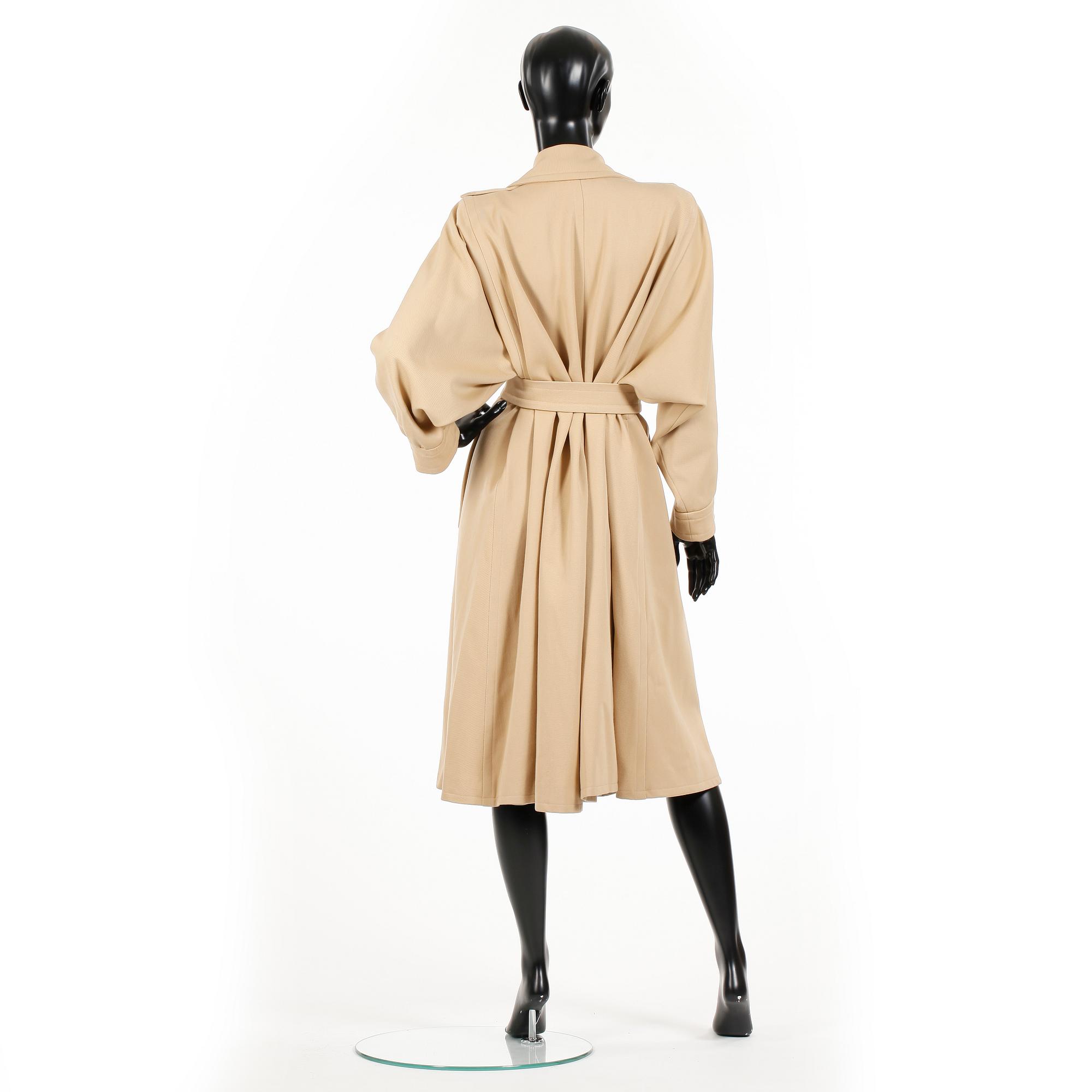 YVES SAINT LAURENT, a beige wool coat.