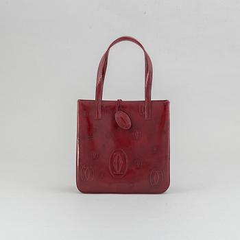 Cartier, a burgundy patent leather handbag and wallet.