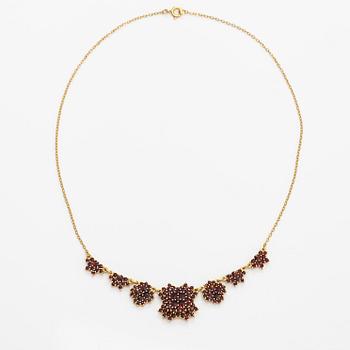 A necklace, earrings and a ring made of gilded silver and garnets.