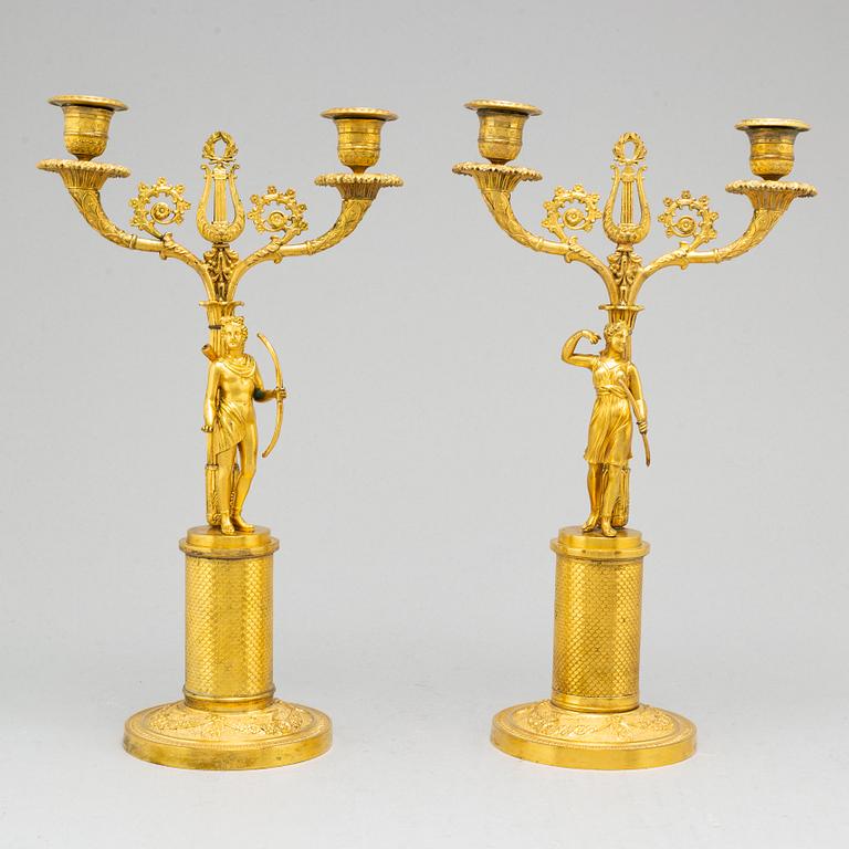 A pair of French Empire two-light gilt bronze candelabra, early 19th century.