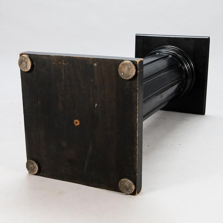 A black lacquered wooden pedestal from around year 1900.