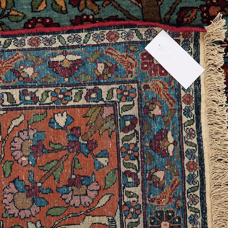 A CARPET, a semi-antique Teheran figural, 303,5 x 198-205,5 cm.