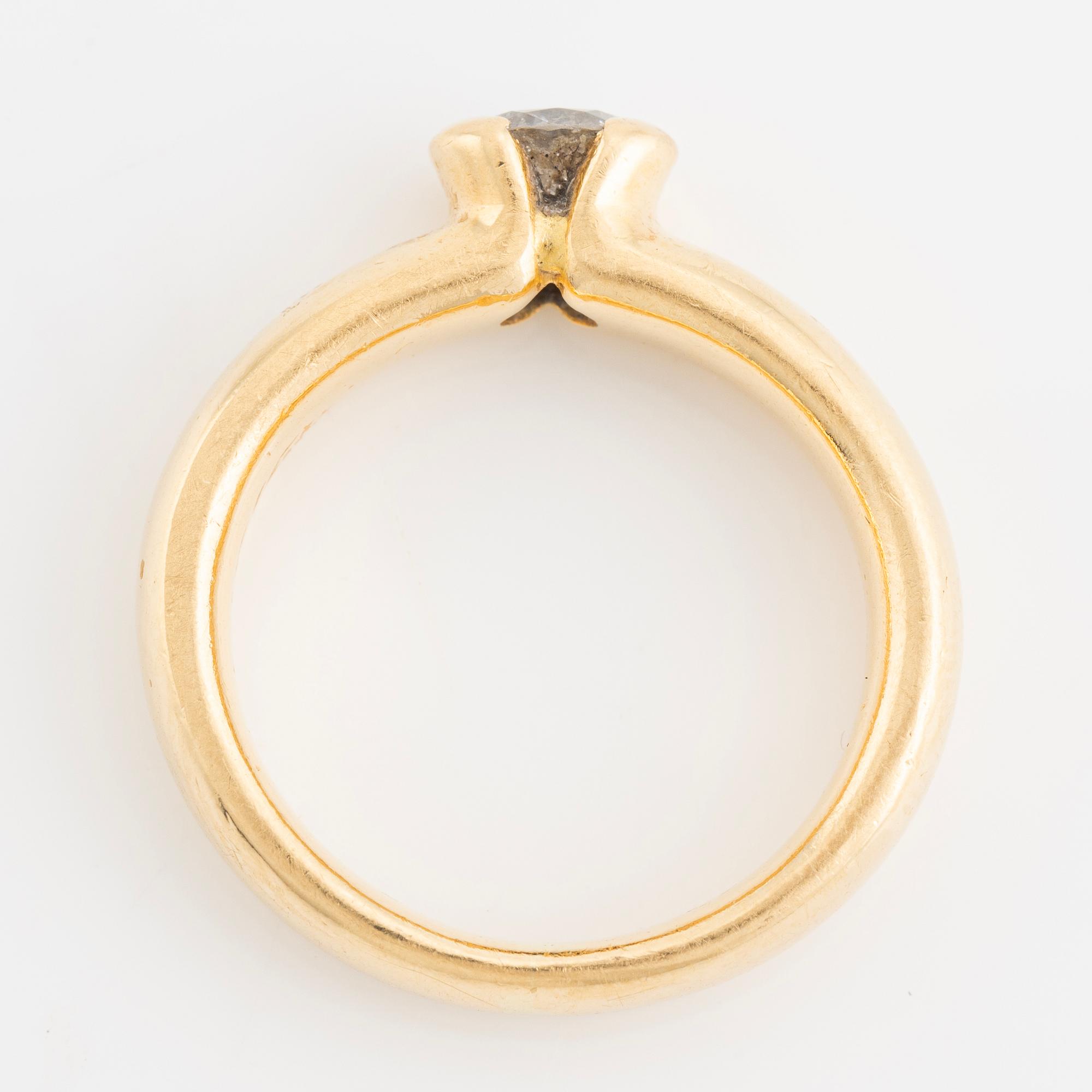 Gold ring with brilliant-cut diamond.