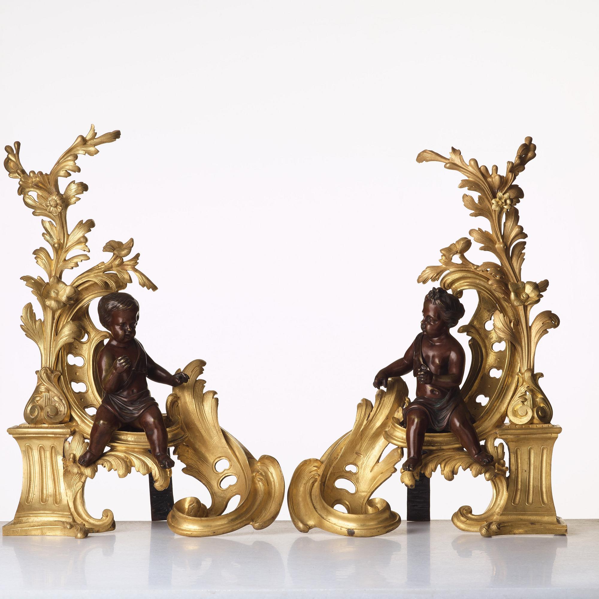 A pair of Louis XV-style 19th century fire dogs.