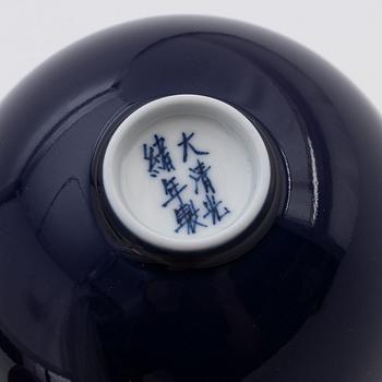 Four Chinese glass snuff bottles and one blue monochrome porcelain bowl, 20th century and modern manufacturing.