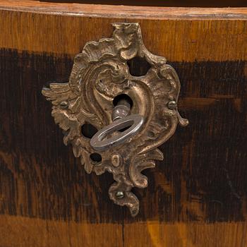 A 19th century Baroque style oak chest of drawers.