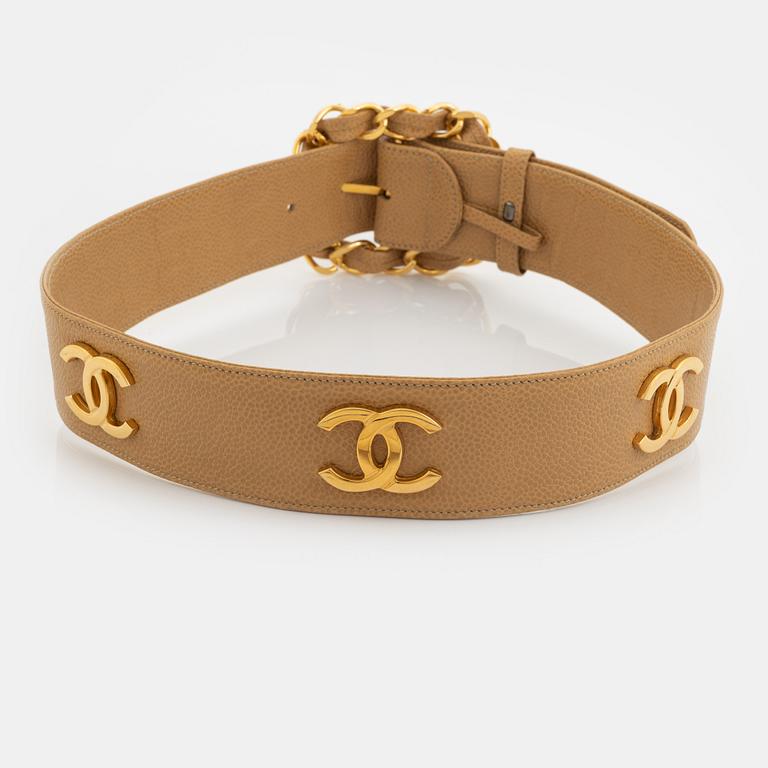 Chanel, a beige caviar letaher and gold tone metal belt.