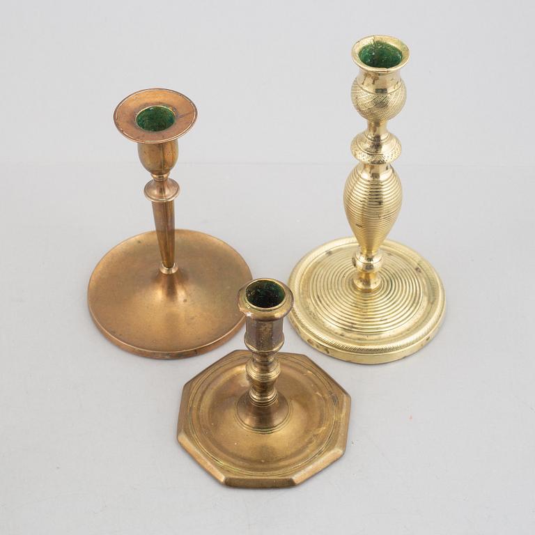 A set of five brass candlesticks, 18th / 19th Century.