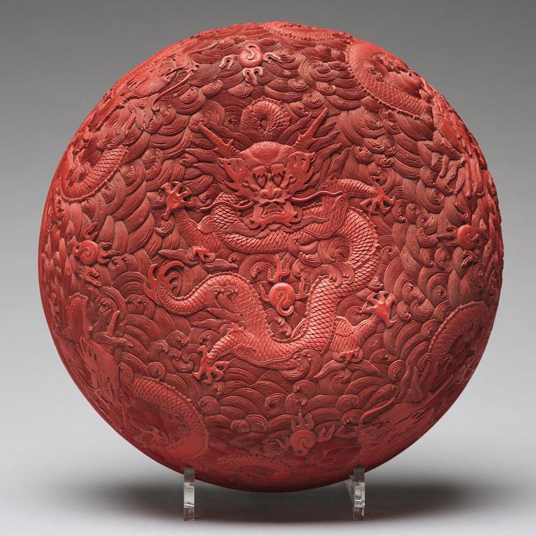 A carved red dragon box with cover, Qing dynasty (1662-1912).