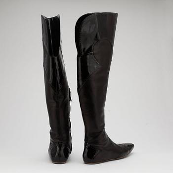 ALEXANDER MCQUEEN, a pair of black leather thigh high boots.