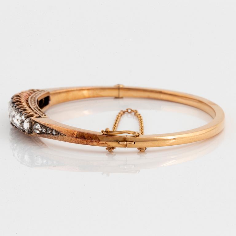 An 18K gold and silver bangle set with rose-cut diamonds.