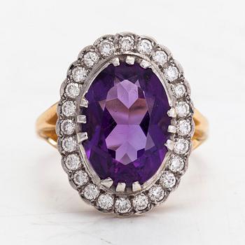 An 18K gold ring, with an oval faceted amethyst and diamonds totaling approximately 0.60 ct. Finnish marks.