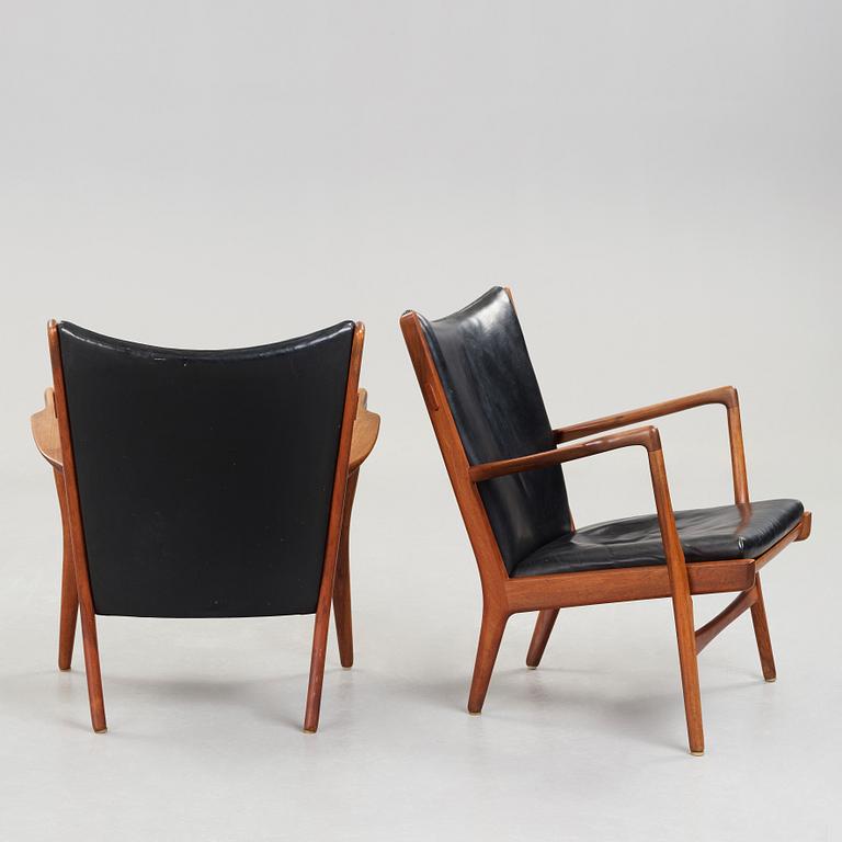Hans J. Wegner, a pair of "AP16" teak and black leather armchairs, AP-stolen, Denmark 1950-60´s.