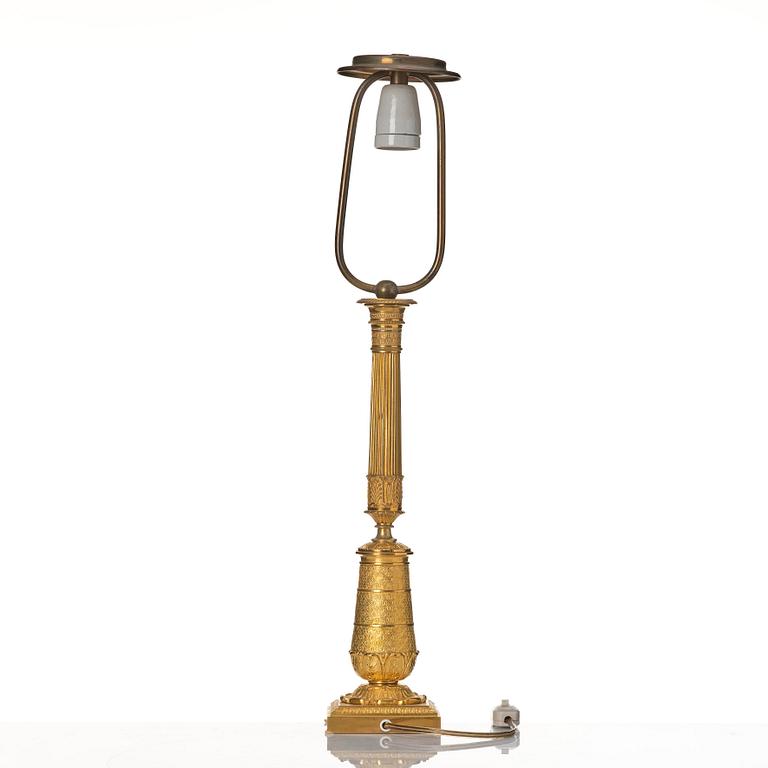 An gilded Empire table lamp.