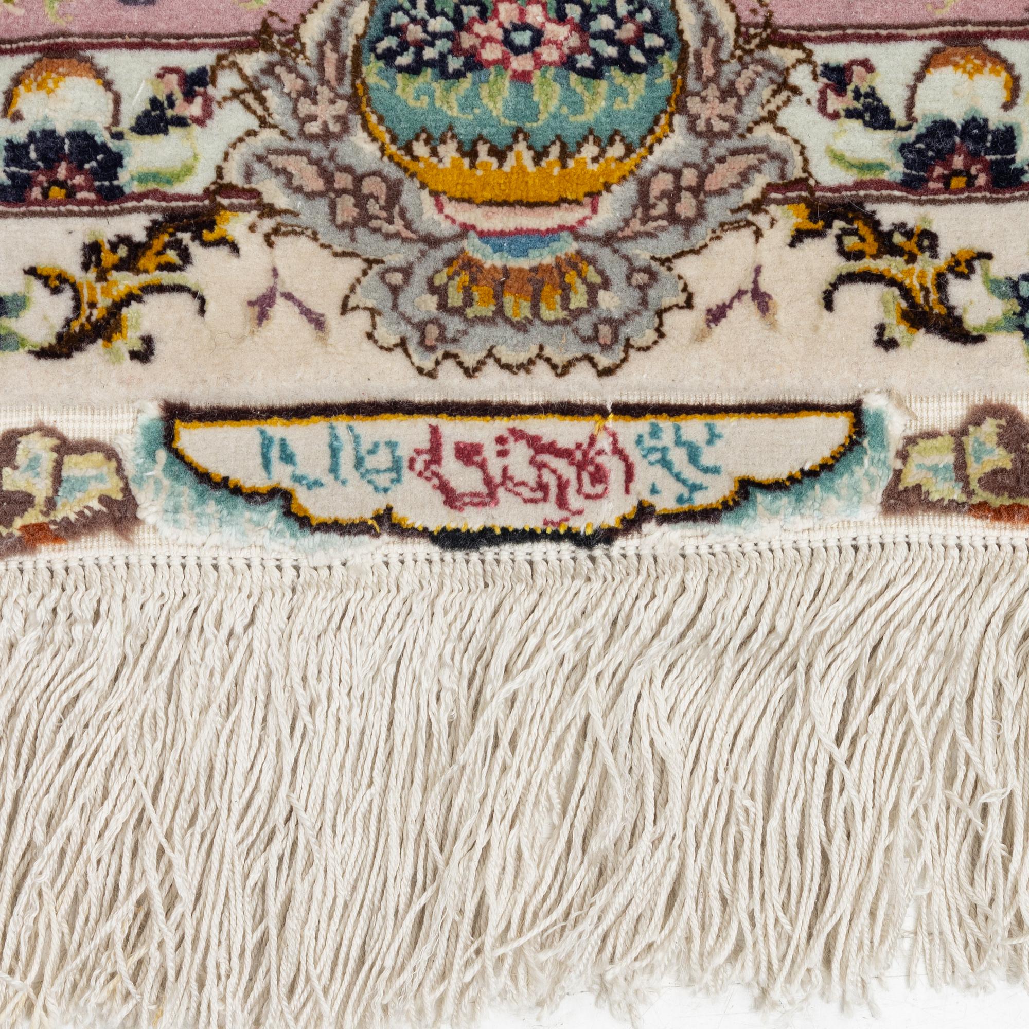 A Tabriz rug, signed, c. 160 x 101 cm.