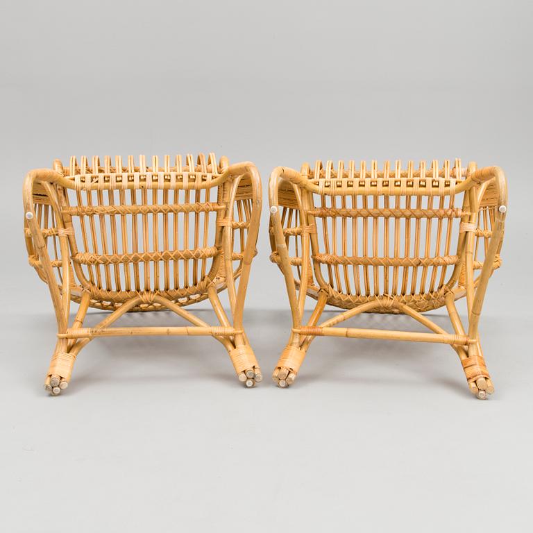 A pair of rattan arm chairs from the latter half of the 20th Century.