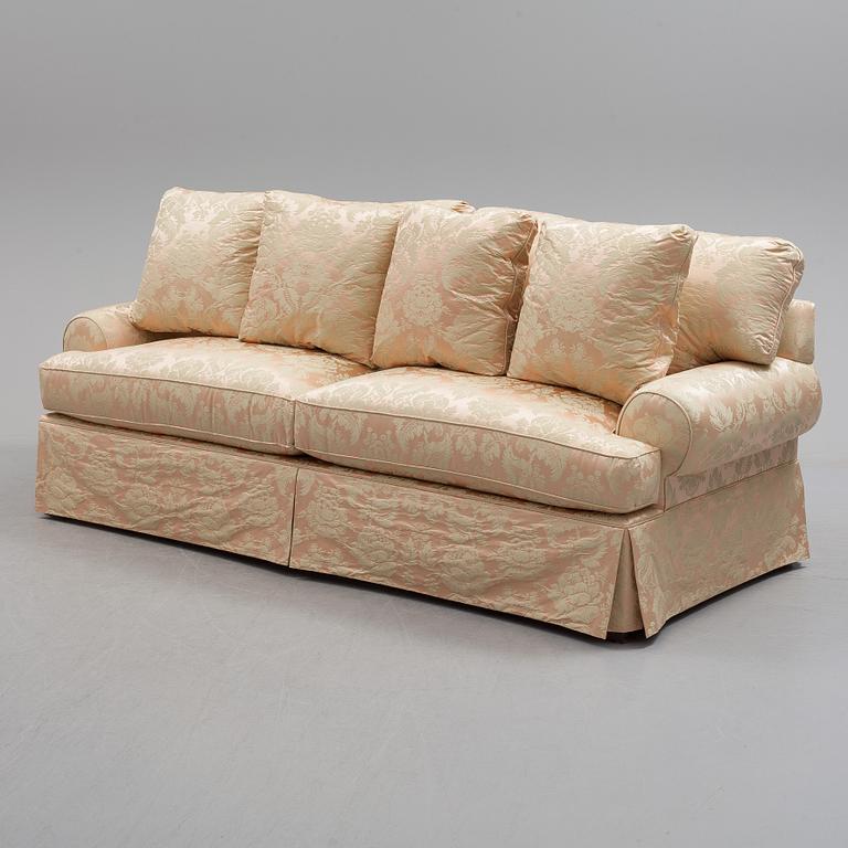 A sofa upholstered with silk damask.