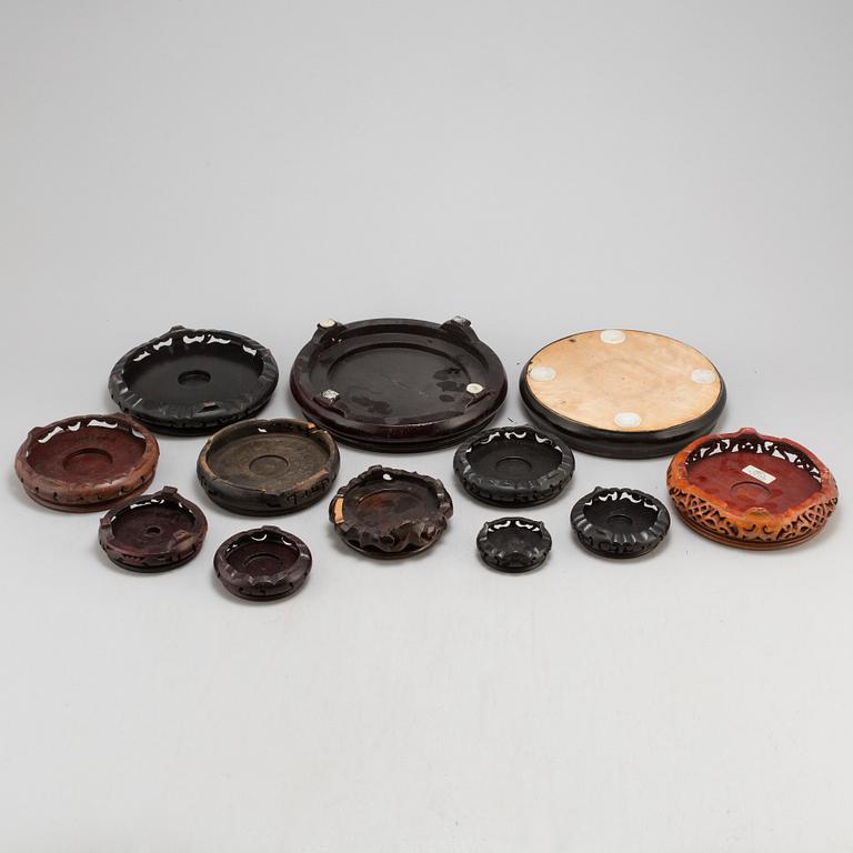 A set of 12 Chinese wooden stands, 19th and 20th Century.