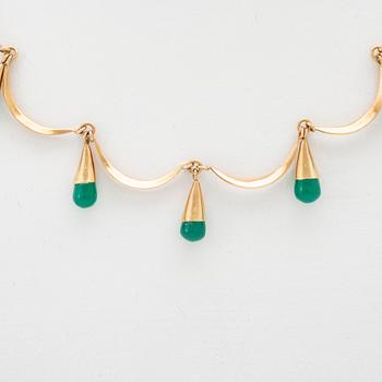 An 18K gold neckalce and a pair of earring set with green stones.