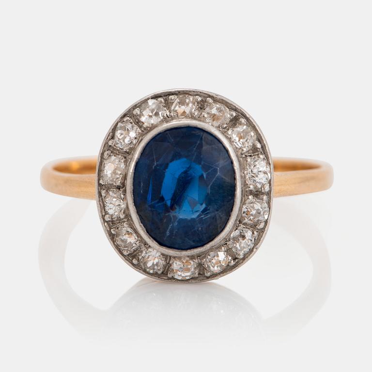 An 18K gold ring set with a faceted sapphire weight ca 2.00 cts and old-cut diamonds.