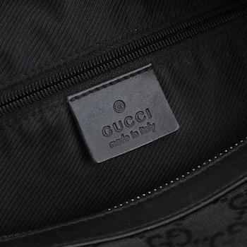 GUCCI, a canvas and leather bag.