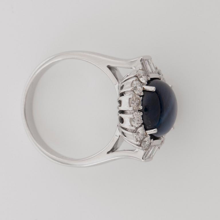 A 6.81 cts star sapphire and brilliant-cut diamond ring. Total carat weight of diamonds 1.05 cts.