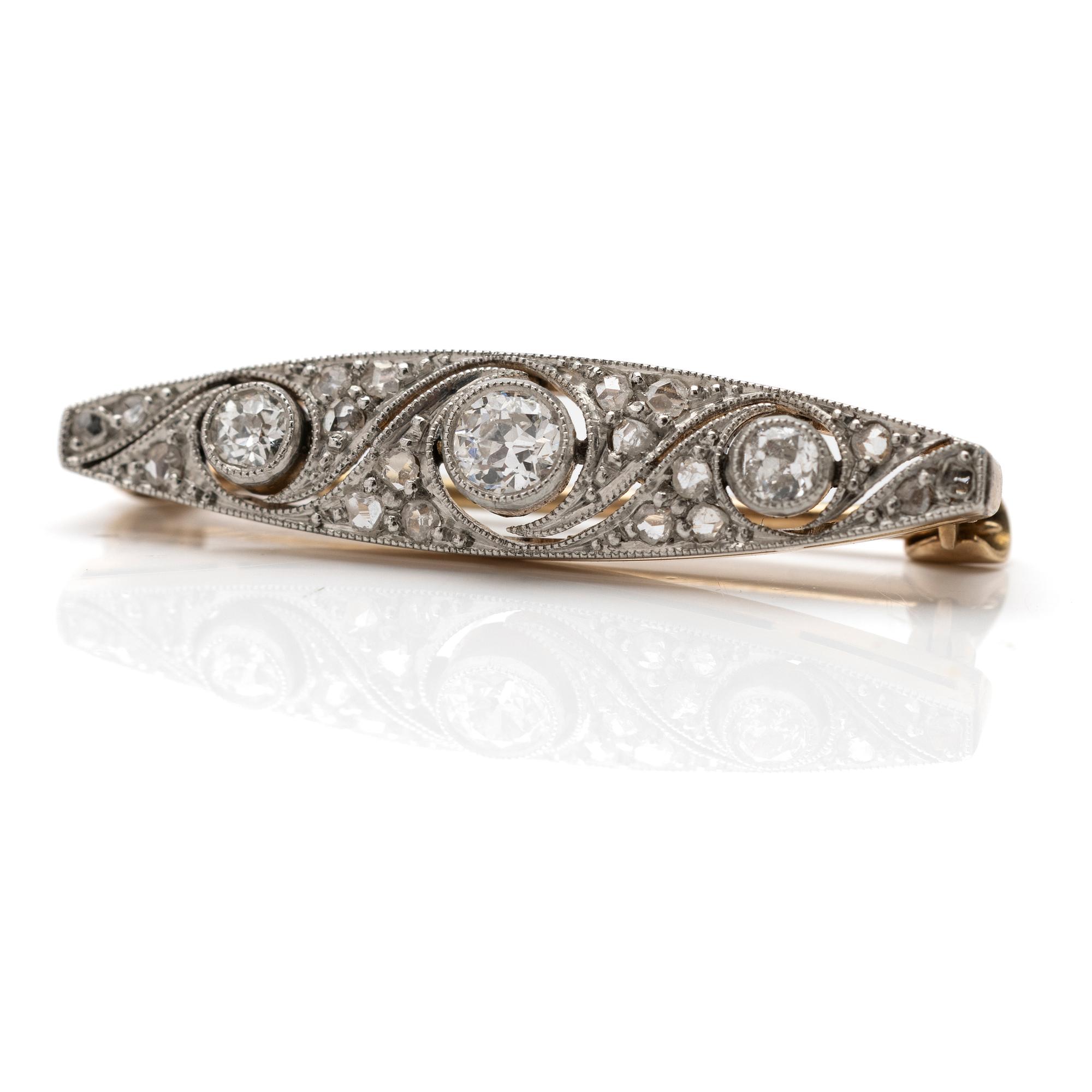 A 14K gold and platinum brooch with diamonds.