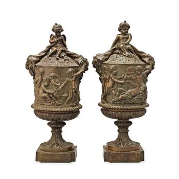 A pair of 19th century bronze urns in the manner of Clodion.