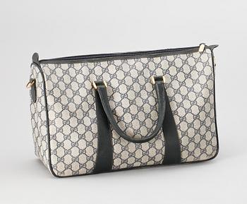 A blue monogram canvas bag by Gucci.