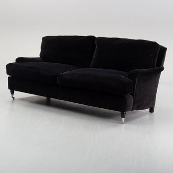 A contemporary velvet Howard sofa.