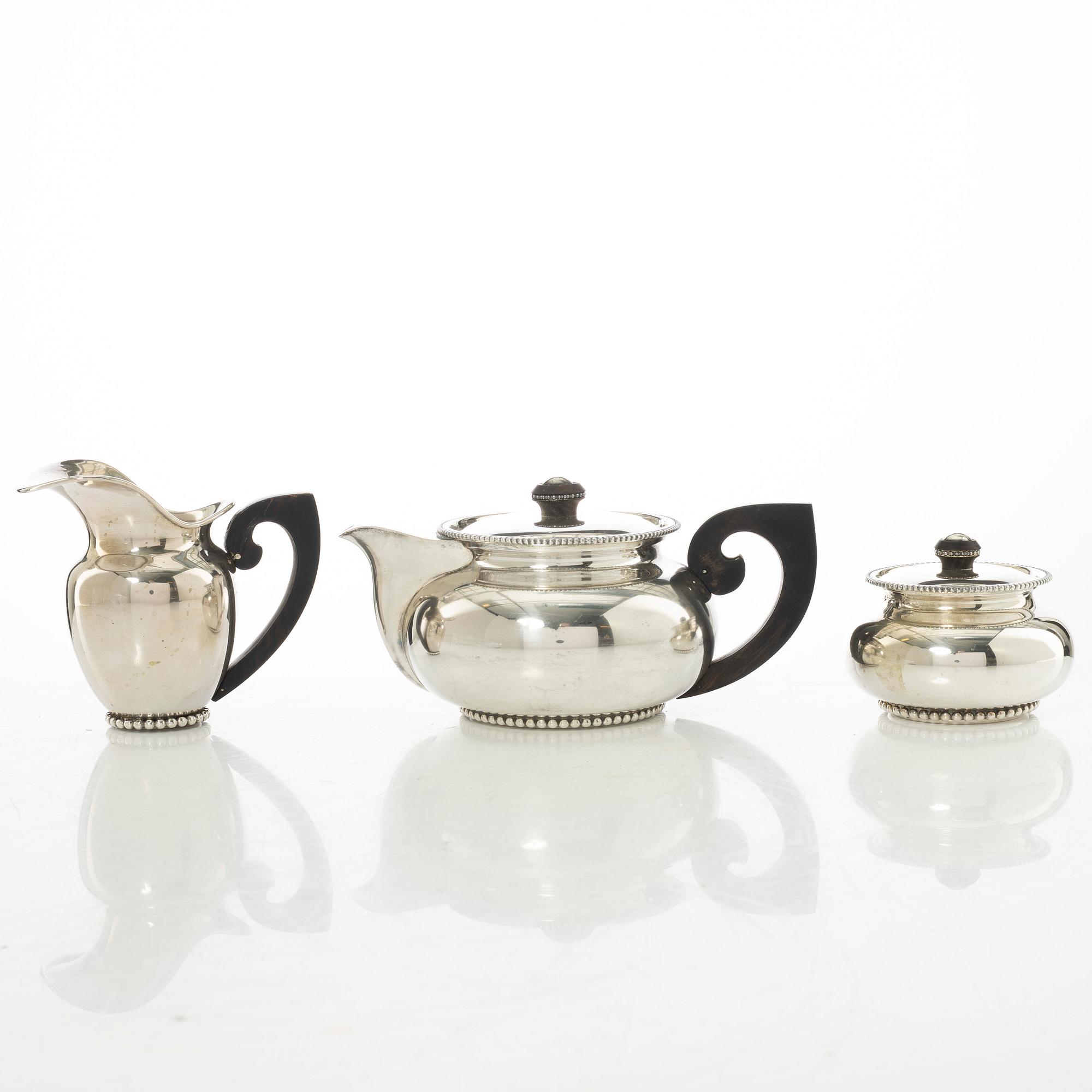 An Italian silver teapot, cream jug and sugar bowl, 20th century.