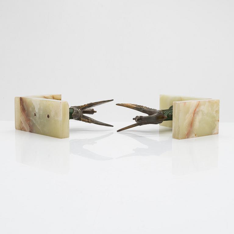A pair of alabaster and  patinated metal Art Deco bookends from the first half of the 20th Century.