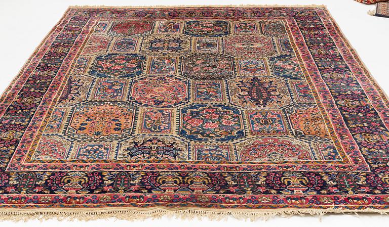 An carpet, possibly Kirman, signed, 350 x 255 cm.