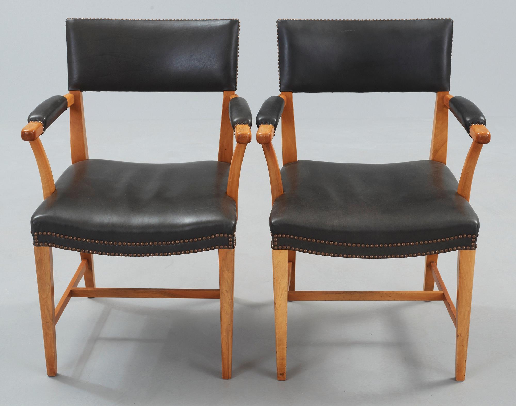 A pair of Josef Frank walnut and black leather armchairs, Svenskt Tenn, model 695.
