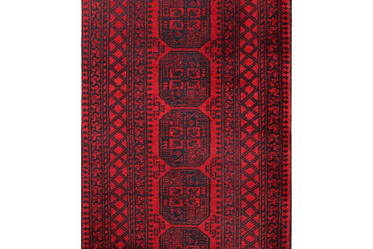 An Afghan runner carpet, c. 380 x 94 cm.