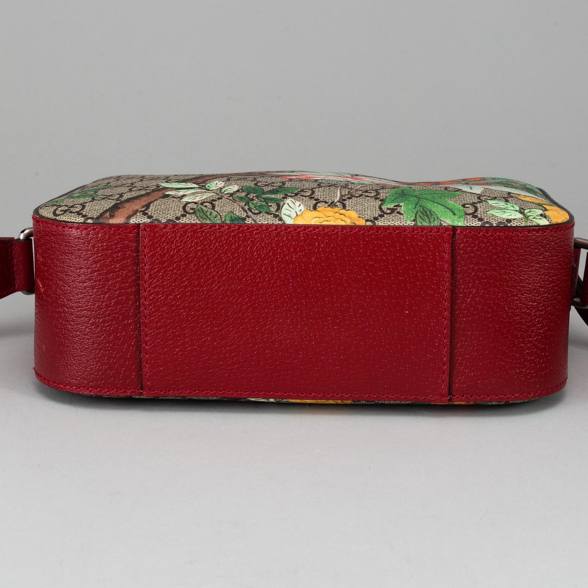 GUCCI, a patterned monogram canvas and leather bag.