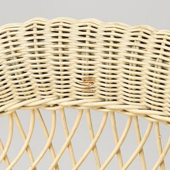A mid-20th-century three-piece rattan furniture set including two armchairs, and a table.